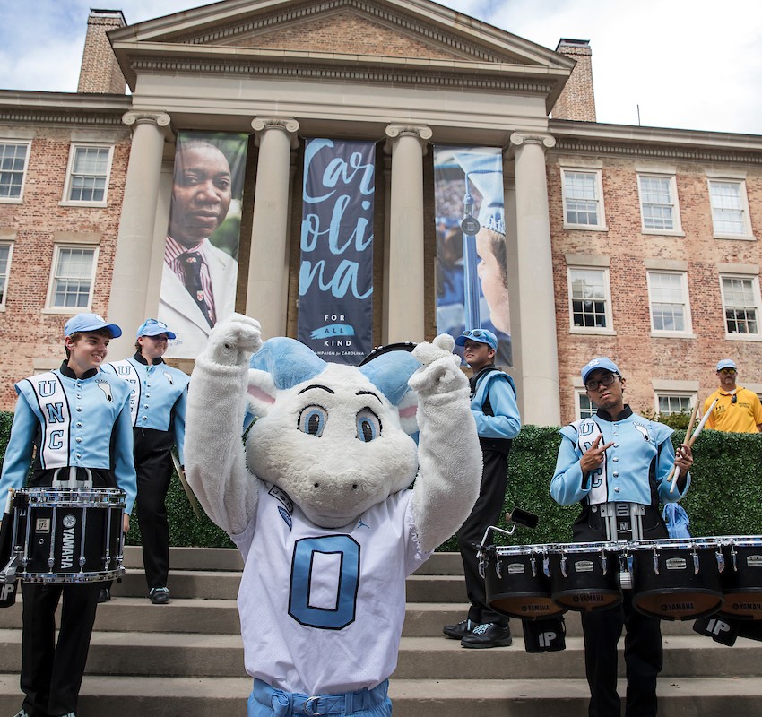 UNC-Chapel Hill pep band playing instruments on the steps of South Building on the UNC campus in Chapel Hill.